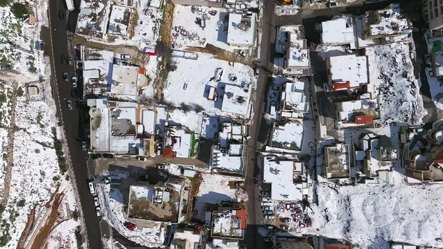 Mountainside Town houses covered with snow, Fly over