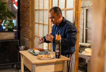 Chef doing final touch to dish at restaurant