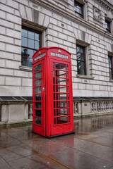 British telephone box in the capital city London. Vintage red phone booth. traditional pay phone kiosk 
