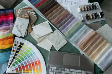Desk with multi colored fabric samples arranged at office