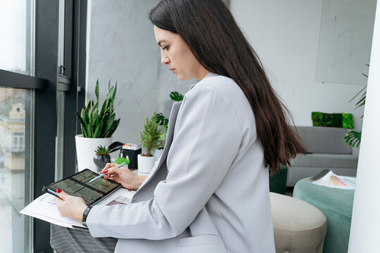 Architect using digital PC sitting in office