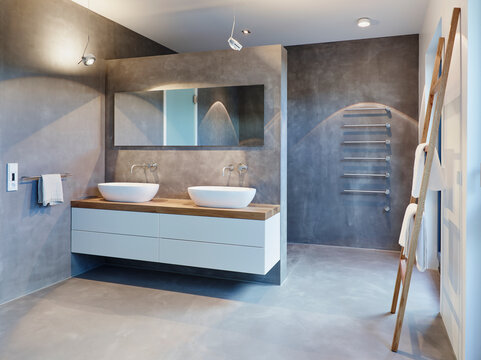 Symmetrical modern bathroom with LED lighting and natural marble