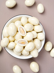 dragee from almonds in white chocolate. Chocolate balls with nut filling.