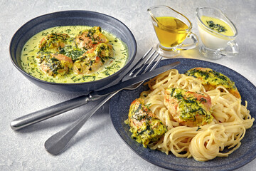 Plate of spaghetti with fried chicken, baked with herbs and crea