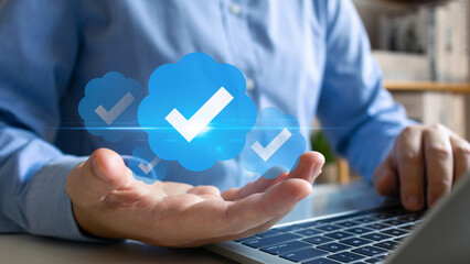 Businessman holding blue check correct mark to verification account on social media platform,...