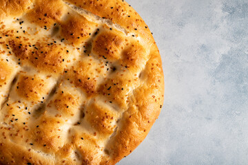 Traditional Ramadan pita on bright blue  background.Holy bread for Muslims