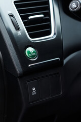 Obraz na płótnie Canvas Economic green mode and electronic stability programme buttons in a modern car near air conditioning system