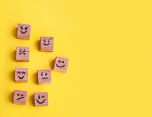 Many cubes with different emotions on yellow background . Empathy and Emotional Intelligence...