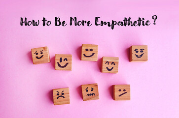 Many cubes with different emotions on pink  background . How to be more empathetic concept  