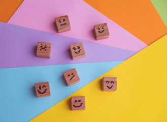 Many cubes with different emotions on colorful background . Empathy and Emotional Intelligence Concept 