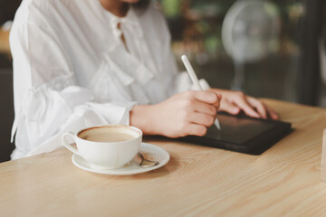 Young beautiful business woman working on laptop at coffee shop concept of independent living, working lifestyle
