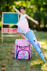 Happy little kid girl with backpack or satchel and big school bag or cone traditional in Germany...