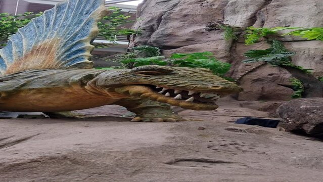 A dinosaur statue is located in the park. which everyone can visit in this place