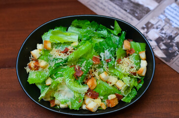 Caesar salad served with organic lettuce, crispy bread and sprinkled with cheese is a meal for health lovers.