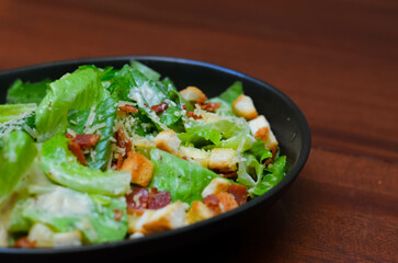 Caesar salad served with organic lettuce, crispy bread and sprinkled with cheese is a meal for health lovers.