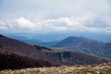 Fototapeta premium Mountain and hill landscape with clouds and fields.