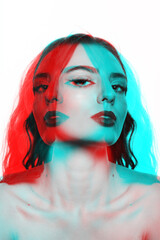 Beautiful woman with wavy long hair and makeup studio portrait. RGB color split and 3D glitch virtual reality effect applied. Model looking with seductive look at camera. Futuristic looking style