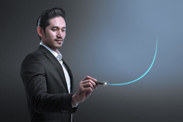 Asian Businessman with a pen drawing a graph