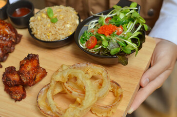 BBQ ribs set served with fried rice, fried chicken wings and onion rings and Japanese salad