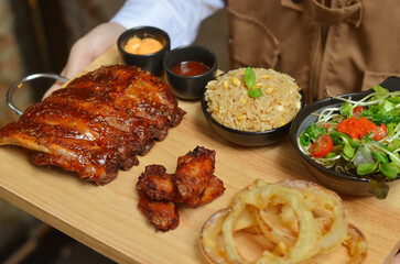 BBQ ribs set served with fried rice, fried chicken wings and onion rings and Japanese salad