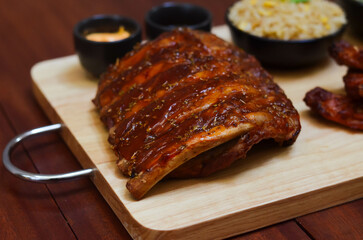 BBQ ribs set served with fried rice, fried chicken wings and onion rings and Japanese salad