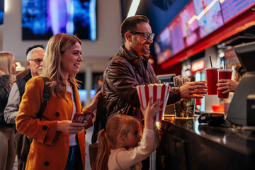 Joyful family in movie theater.