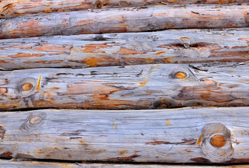 A fragment of an old log wall on a winter day