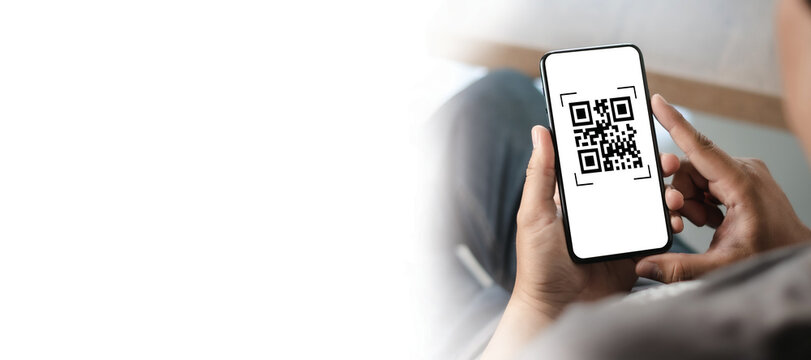 scanning QR codes with a mobile phone application and paying for goods and services in the retail supermarket background