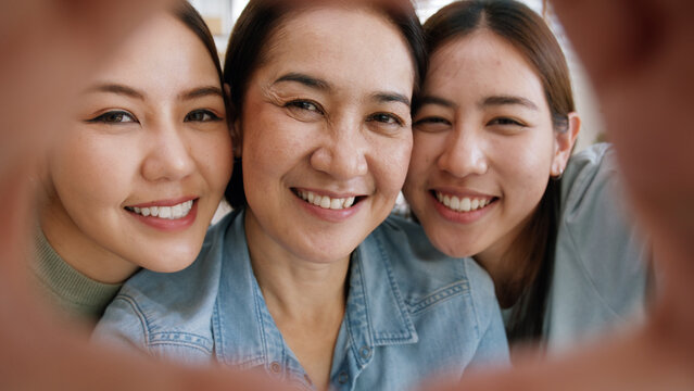 Enjoy Good Warm Time Mother Day Two Grown Up Kid Child Girl Look At Camera Joy Cuddle Hug Make Heart Shape Love Hand Sign To Mature Mum. Asia Middle Age Mom Young Adult Three People Smile Happy Face