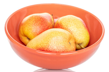 Three ripe yellow-red pears in a plate, on a white background.