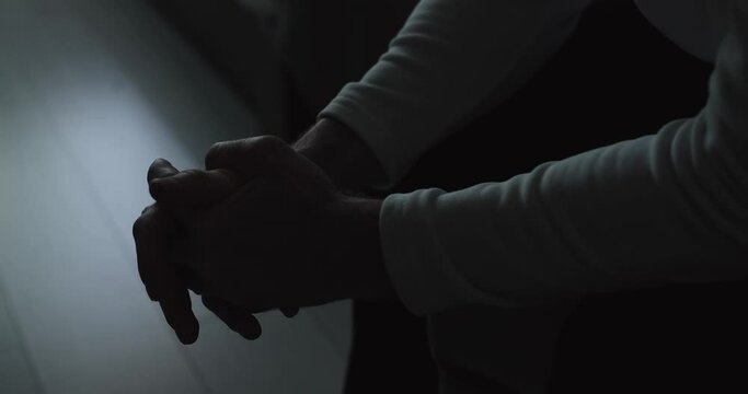 Closeup hands of stressed nervous man sitting at home 