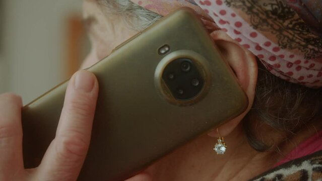 Keeping in Touch: Close-Up of Senior Woman Using Smartphone to Talk with Someone