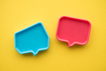 Chat bubbles on social media communication. Blue and red chat bubbles icon messages on yellow background minimal style. Social media online, social network concept.