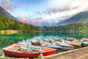 Naklejka premium Incredible view of sunset over Fusine lake with Mangart peak on background.