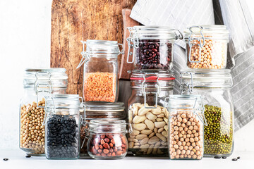 Legumes and beans set in jars. Dried, raw Lentils, chickpeas, mung beans, soybeans, edamame, peas. Healthy diet food, vegan protein, micronutrients and fiber sources - obrazy, fototapety, plakaty