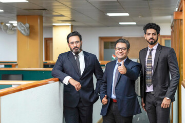 Indian business people showing thumps up at office