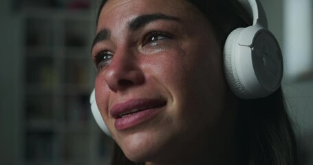 Portrait of Crying Sad Woman Listening to Music and Using Headphones During Evening. Female Getting Nostalgic and Emotional After Breakup While Listening to Sad Songs. Mental Health Struggles Concept