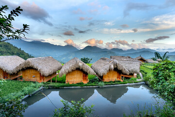 Wooden bungalows from above with breathtaking views of the mountains and terraced fields where you...