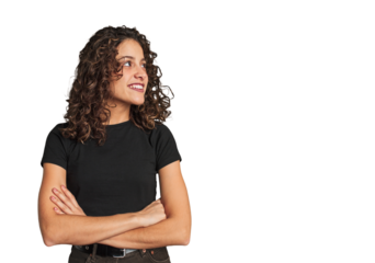 Radiant young woman with stunning curls smiling confident with crossed arms.
