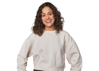 Radiant young woman with stunning curls confident keeping hands on hips.