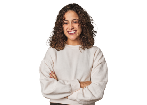 Radiant young woman with stunning curls who feels confident, crossing arms with determination.