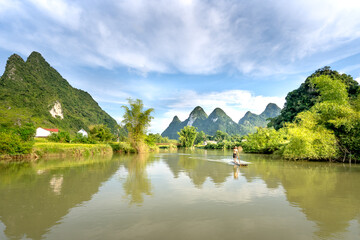 Fototapeta na wymiar Fishermen fishing on Quay Son River in Phong Nam District, Cao Bang Province, Vietnam