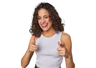 Radiant young woman with stunning curls pointing to front with fingers.