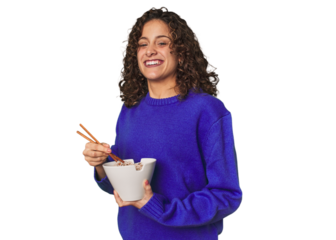 A young caucsian woman eating noddles with chopsticks, very happy