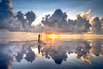 The image of fishermen in the fishing village using homemade tools to clams rake in Diem Dien Beach, Thai Thuy Commune, Thai Binh Province, Vietnam