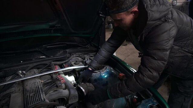 a mechanic disassembles a car to install a turbo engine tuning drift auto