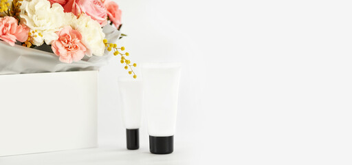 cosmetic beauty product bottle mockup and flower