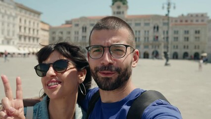 Young couple traveling and vlogging . Young man and woman influencers recording with camera and making video content.