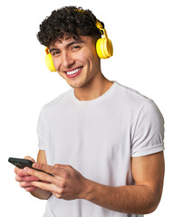 A young man gets lost in music and selects his favorite playlist on his mobile phone while enjoying...