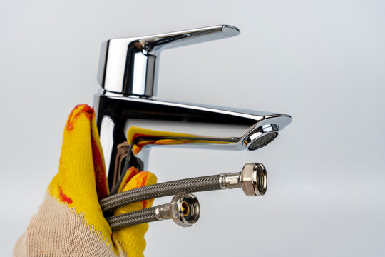  Shiny New Sink Faucet In The Hand Of A Gloved Plumber. Sink Mixer